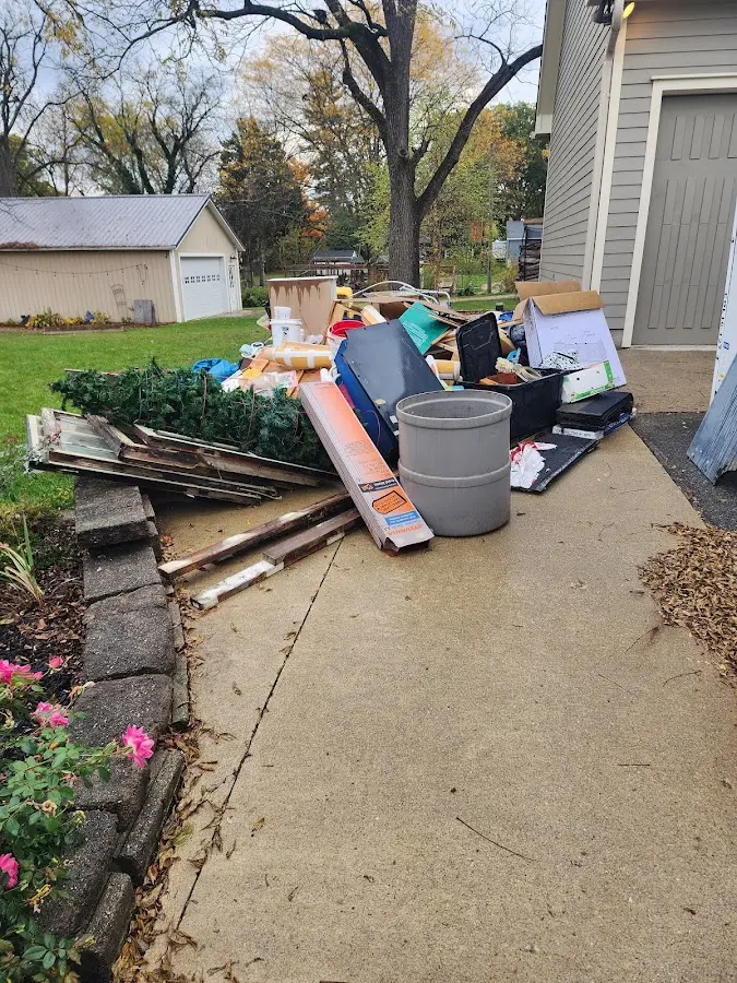 Dumpster being loaded with debris for Roofing Dumpster Rental in Yankee Springs